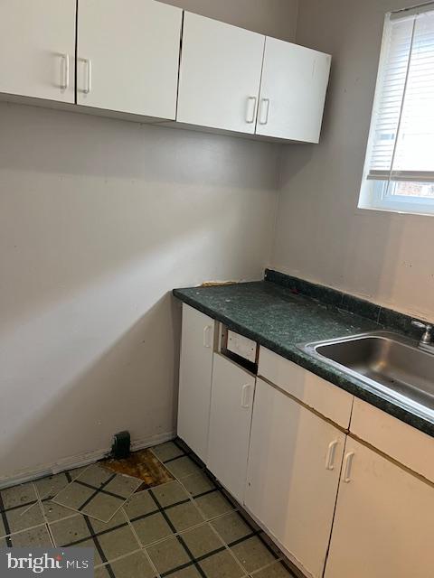 kitchen with white cabinetry and sink