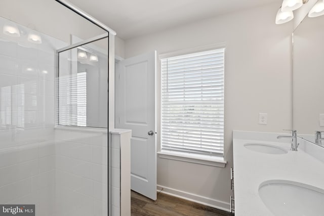 bathroom with vanity, an enclosed shower, and hardwood / wood-style floors