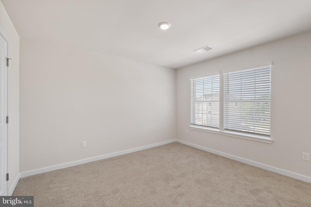 empty room featuring light colored carpet