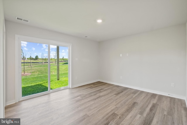 spare room with light hardwood / wood-style floors