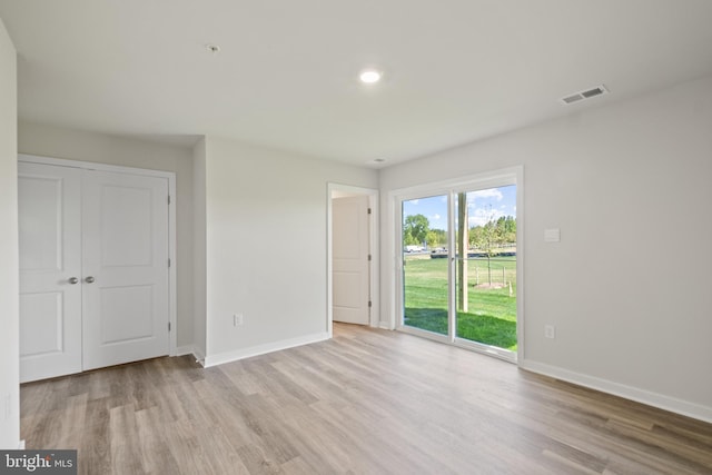 spare room with light hardwood / wood-style flooring