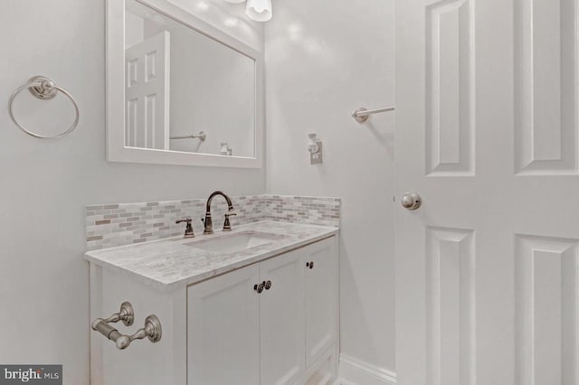 bathroom featuring vanity and decorative backsplash