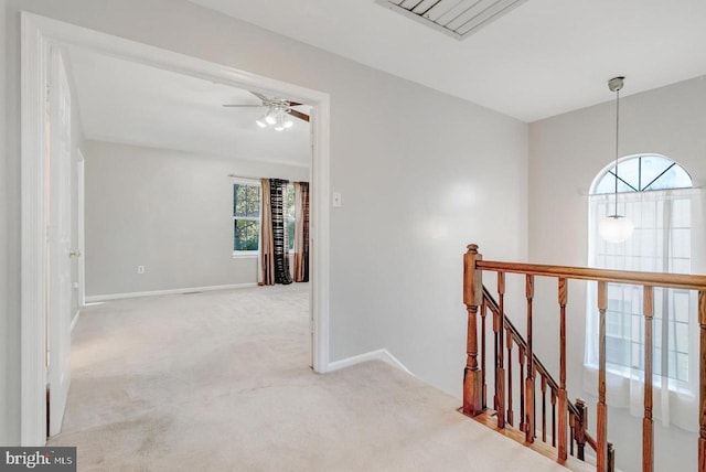 corridor featuring light colored carpet