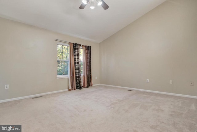 carpeted spare room featuring lofted ceiling and ceiling fan