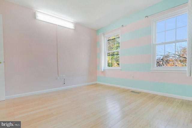 spare room with light hardwood / wood-style flooring