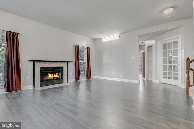 unfurnished living room featuring wood-type flooring and a premium fireplace