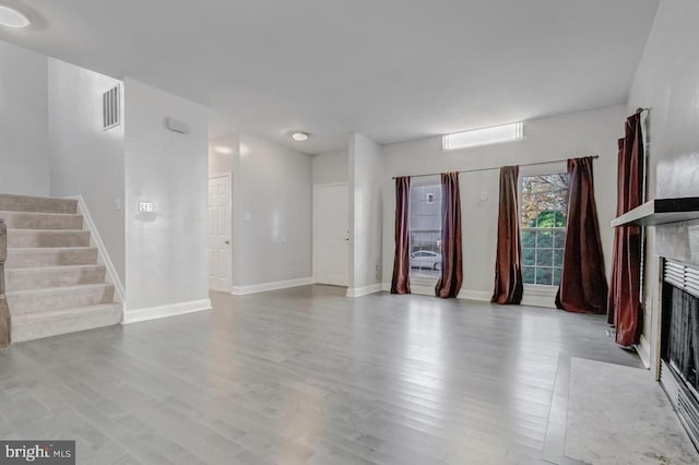 unfurnished living room with light hardwood / wood-style flooring