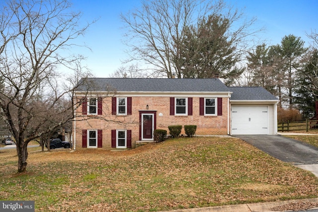 view of front of home featuring a garage and a front yard