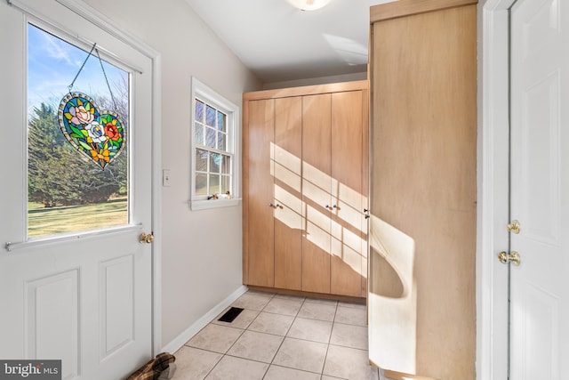 entryway with light tile patterned floors, visible vents, and baseboards