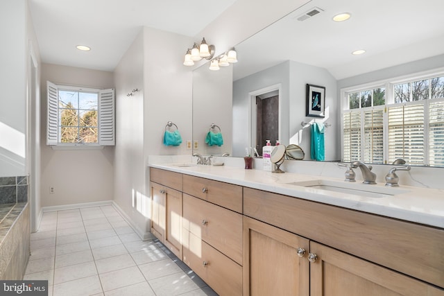 bathroom with double vanity, visible vents, a sink, and tile patterned floors