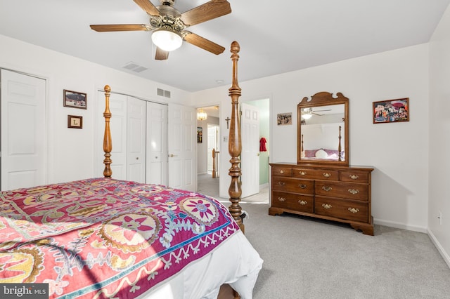 bedroom with light carpet, baseboards, visible vents, and a closet