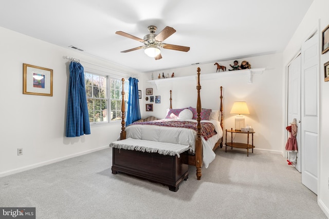 bedroom featuring baseboards, visible vents, and light colored carpet