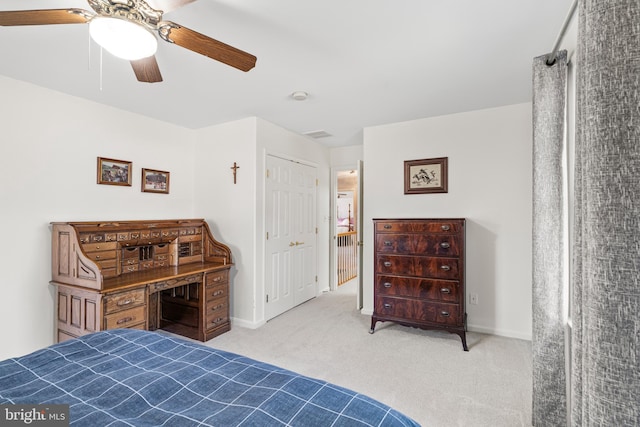 bedroom with light colored carpet, ceiling fan, and baseboards