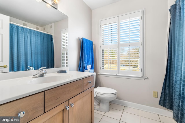 bathroom featuring toilet, tile patterned flooring, vanity, and baseboards