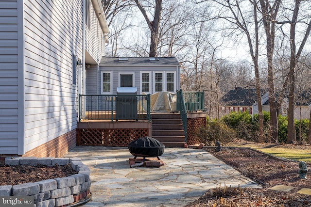 exterior space featuring an outdoor fire pit, area for grilling, and a patio