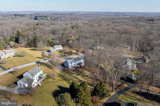 drone / aerial view with a wooded view