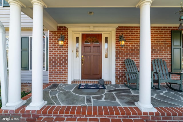 doorway to property with brick siding