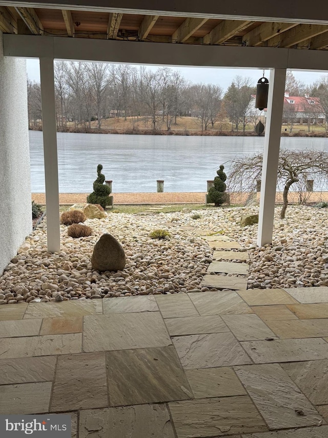 view of patio with a water view