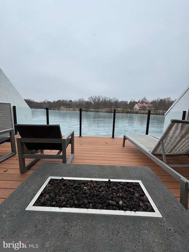 dock area featuring a water view and an outdoor fire pit