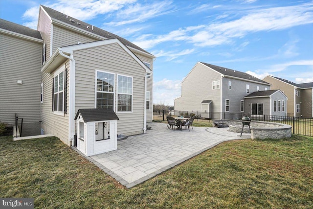 rear view of property with a patio and a lawn