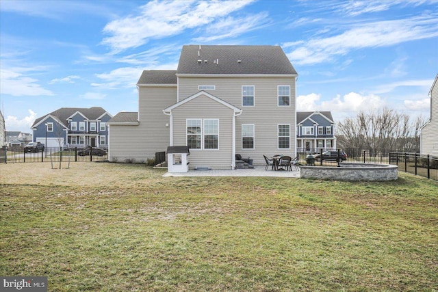 back of house with a patio and a lawn