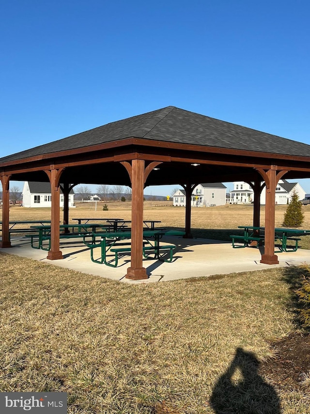 surrounding community with a yard and a gazebo