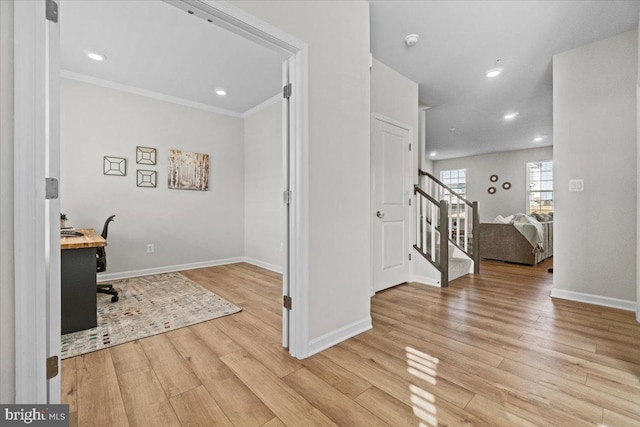 home office featuring ornamental molding and light hardwood / wood-style floors