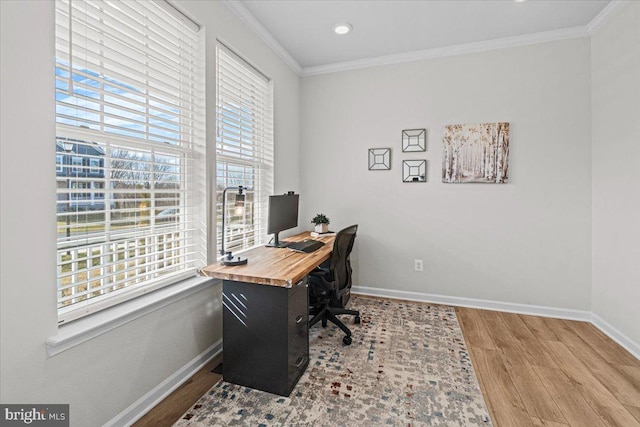 office space with ornamental molding and light hardwood / wood-style floors