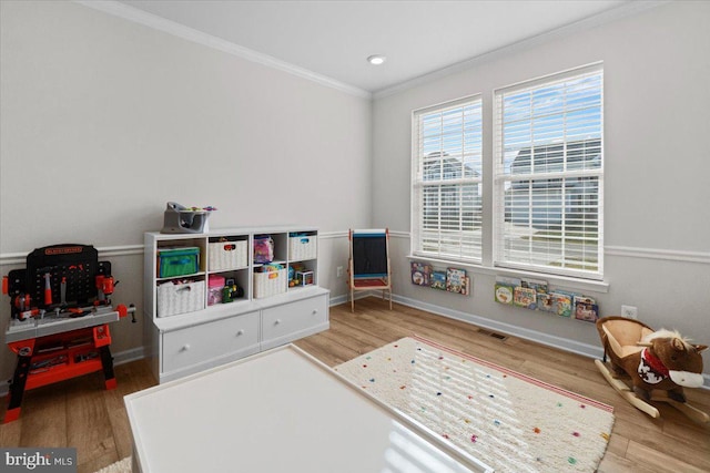 rec room featuring hardwood / wood-style floors and ornamental molding