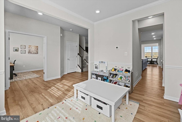 living room featuring ornamental molding and light wood-type flooring