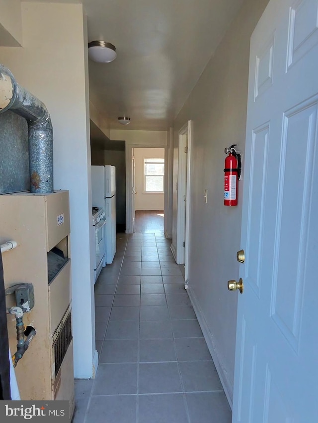 hall with dark tile patterned flooring