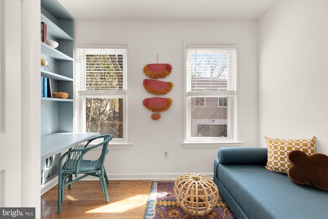 office space featuring plenty of natural light, baseboards, and wood finished floors