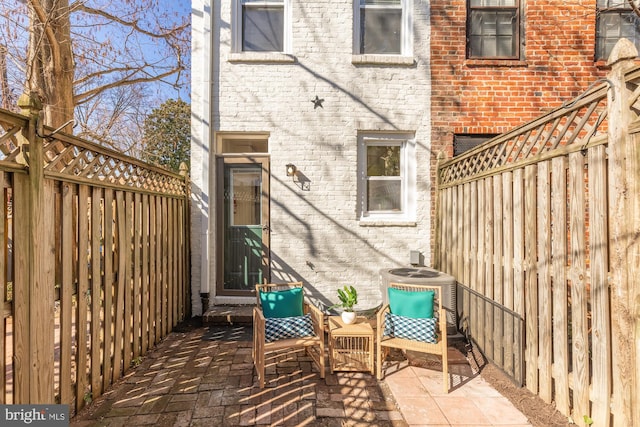 view of patio / terrace with cooling unit and fence