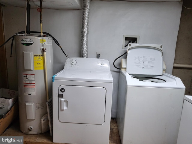 clothes washing area with electric water heater and washer and dryer