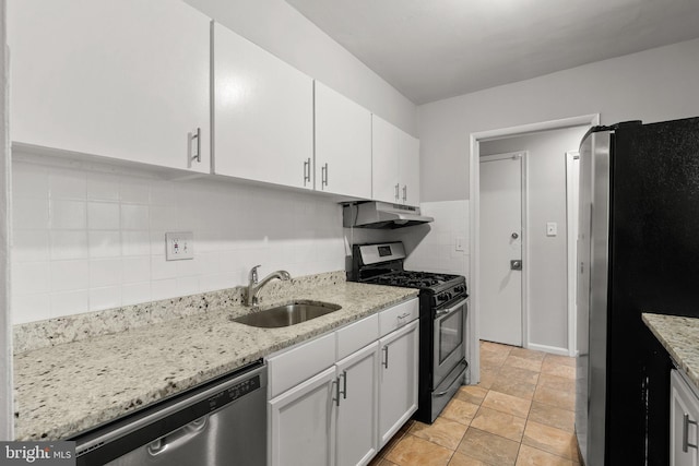 574 Wilson Bridge Dr Unit D-2, Oxon Hill, MD 20745 - kitchen featuring light stone counters, appliances with stainless steel finishes, sink, and white cabinets
