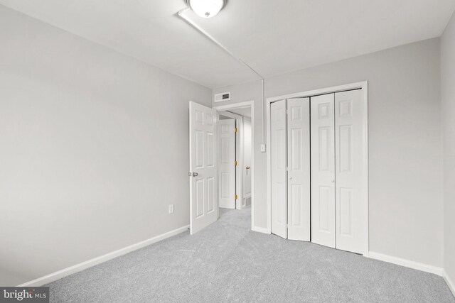 574 Wilson Bridge Dr Unit D-2, Oxon Hill, MD 20745 - unfurnished bedroom featuring light carpet and a closet