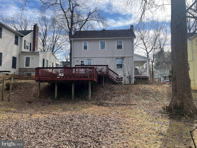 rear view of property featuring a wooden deck