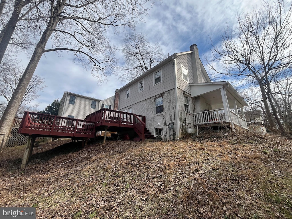 back of property featuring a wooden deck