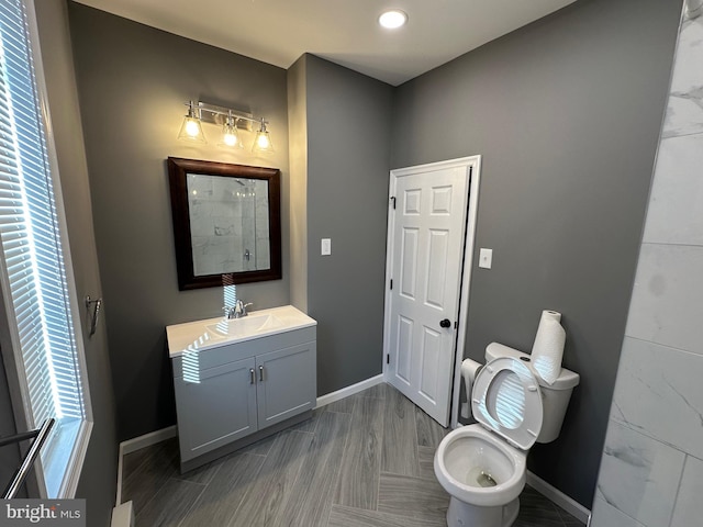 bathroom featuring vanity, hardwood / wood-style floors, and toilet