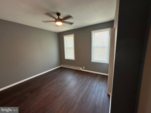 spare room with ceiling fan, dark wood-type flooring, and baseboard heating