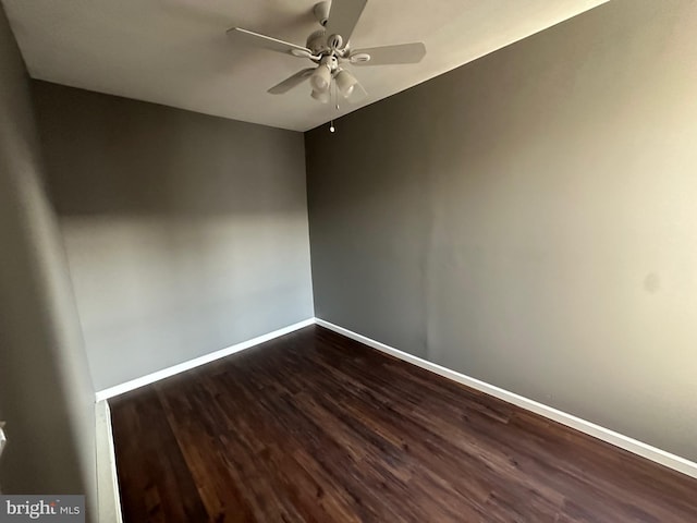 spare room featuring dark hardwood / wood-style floors and ceiling fan