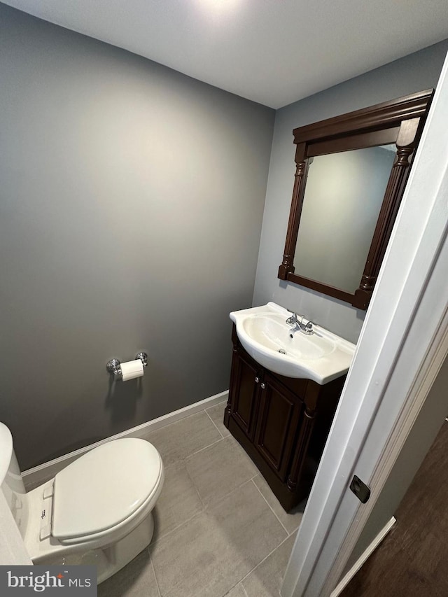 bathroom with tile patterned floors, vanity, and toilet