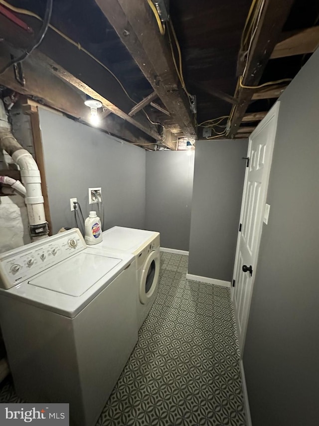 clothes washing area featuring separate washer and dryer