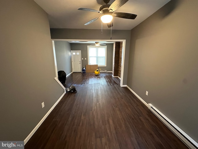 empty room with dark wood-type flooring, ceiling fan, and baseboard heating