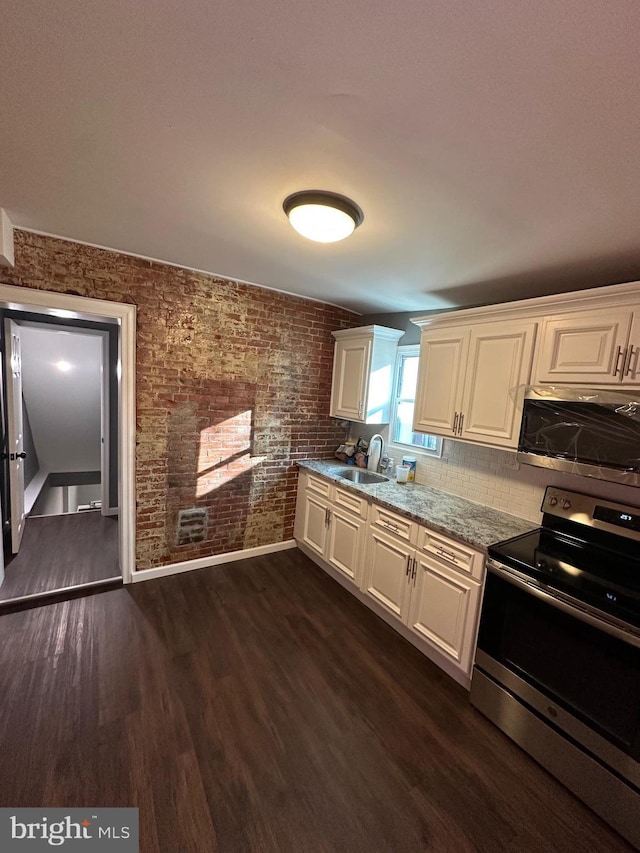 kitchen with dark hardwood / wood-style flooring, sink, white cabinets, and appliances with stainless steel finishes