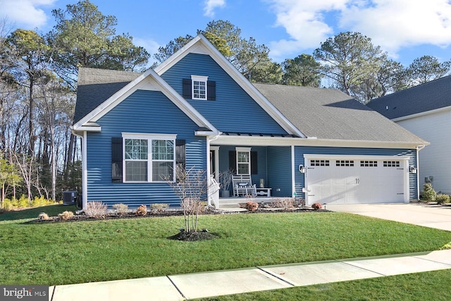 view of front of home featuring a porch, central AC, a garage, and a front yard