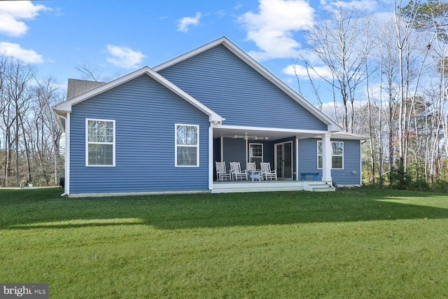 back of property with a yard and covered porch