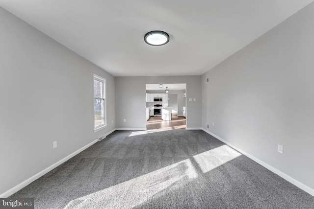 unfurnished living room featuring carpet flooring