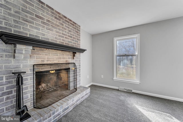 unfurnished living room with a fireplace and carpet