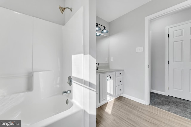 bathroom with vanity, hardwood / wood-style floors, and tub / shower combination